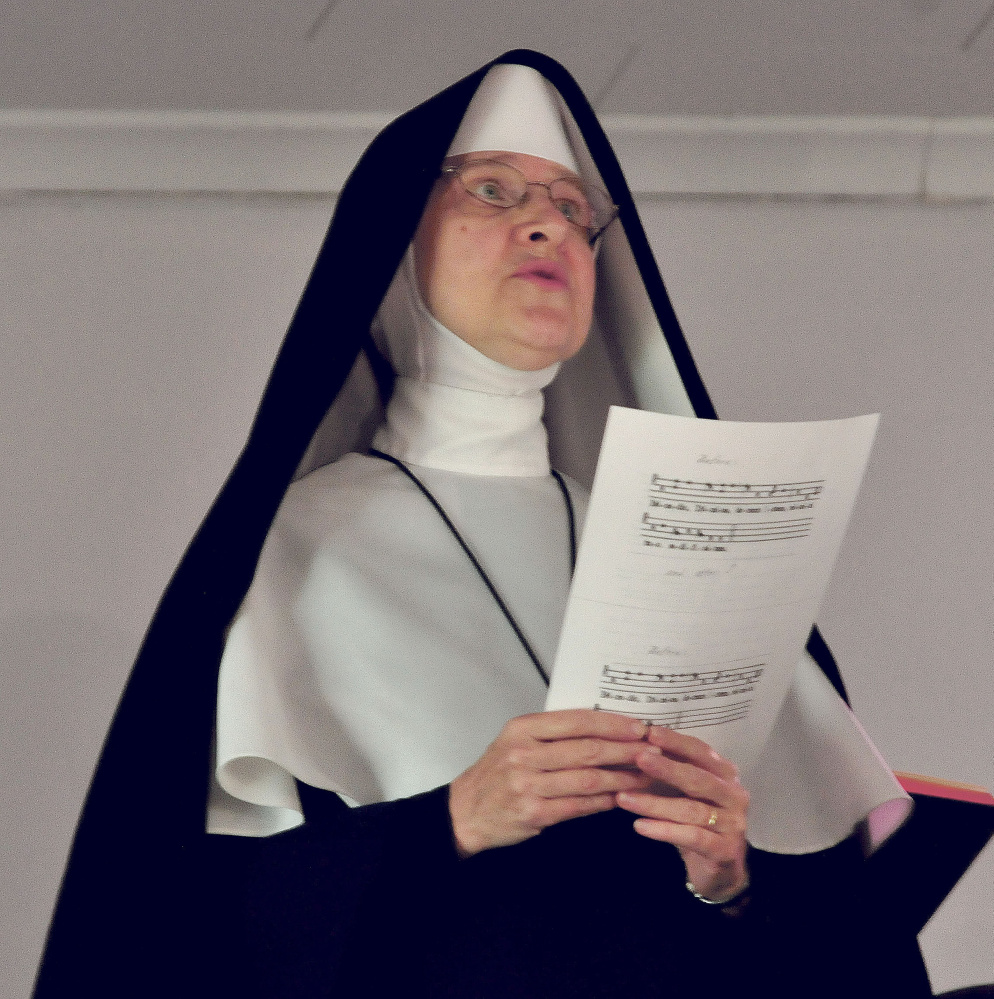 A nun sings hymns during a blessing of the St. Theresa’s Church in Oakland on Thursday.
