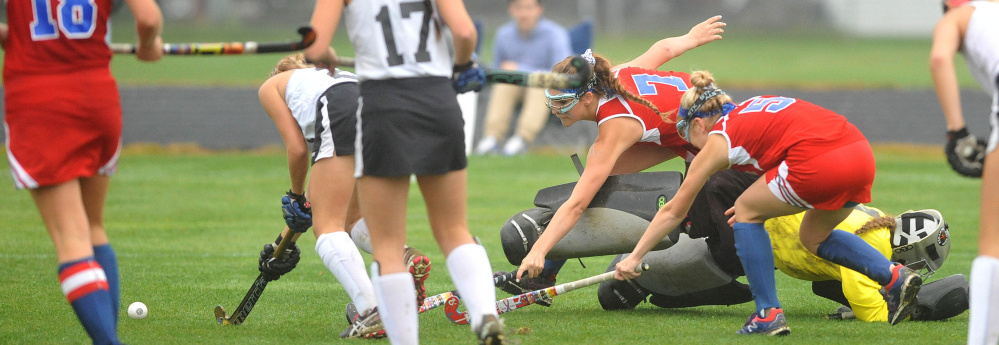 Staff photo by Michael G. Seamans
Messalonskee’s Emily Hogan, right back, and Emily Warren, right, dive over Skowhegan goalie Leah Kruse for the ball as Skowhegan defender Maliea Kelso defends during a Class A North game Tuesday in Skowhegan. The Eagles and Indians are the No. 1 and No. 2 seeds, respectively, in the Class A North tournament.