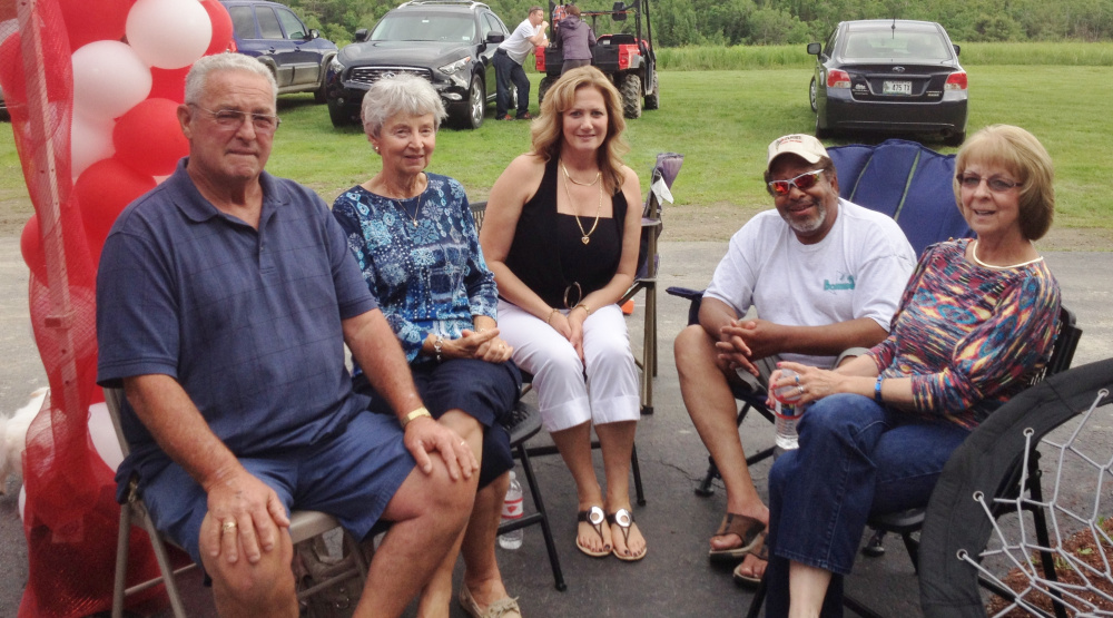 Dan Alexander, left, is shown here visiting with friends at a graduation party.