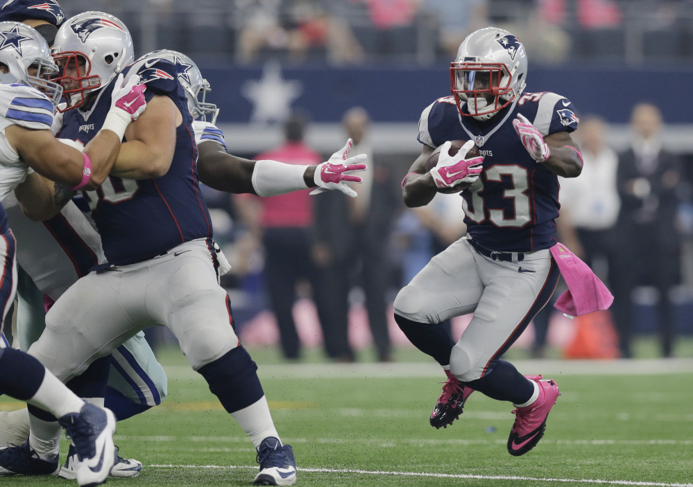 New England’s Dion Lewis (33) runs against the Dallas Cowboys during the first quarter Sunday in Arlington, Texas. In their last four games against the Indianapolis Colts, the Patriots have gained 722 yards and scored 15 touchdowns on the ground.