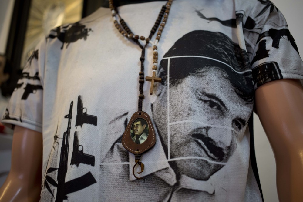 A T-shirt of fugitive Mexican drug lord Joaquin “El Chapo” Guzman covers a mannequin representing Jesus Malverde, known in Mexico as the “Saint” of drug traffickers, inside the shrine of a faith healer in Mexico City, Friday.