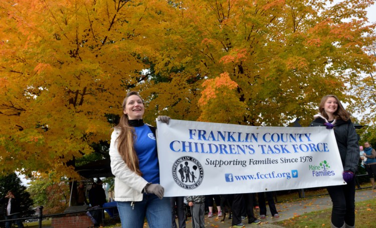 Stacie Bourassa, left, and her daughter Anna, 13, lead a fundraising walk benefiting child-abuse prevention education and resources Saturday in Farmington.