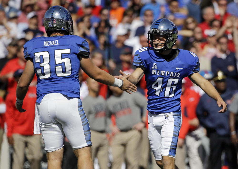 Memphis place kicker Jake Elliott (46) is congratulated by holder Evan Michael (35) after Elliott kicked a 27-yard field goal against Mississippi in the second half Saturday in Memphis, Tenn. Memphis upset No. 13 Mississippi 37-24.