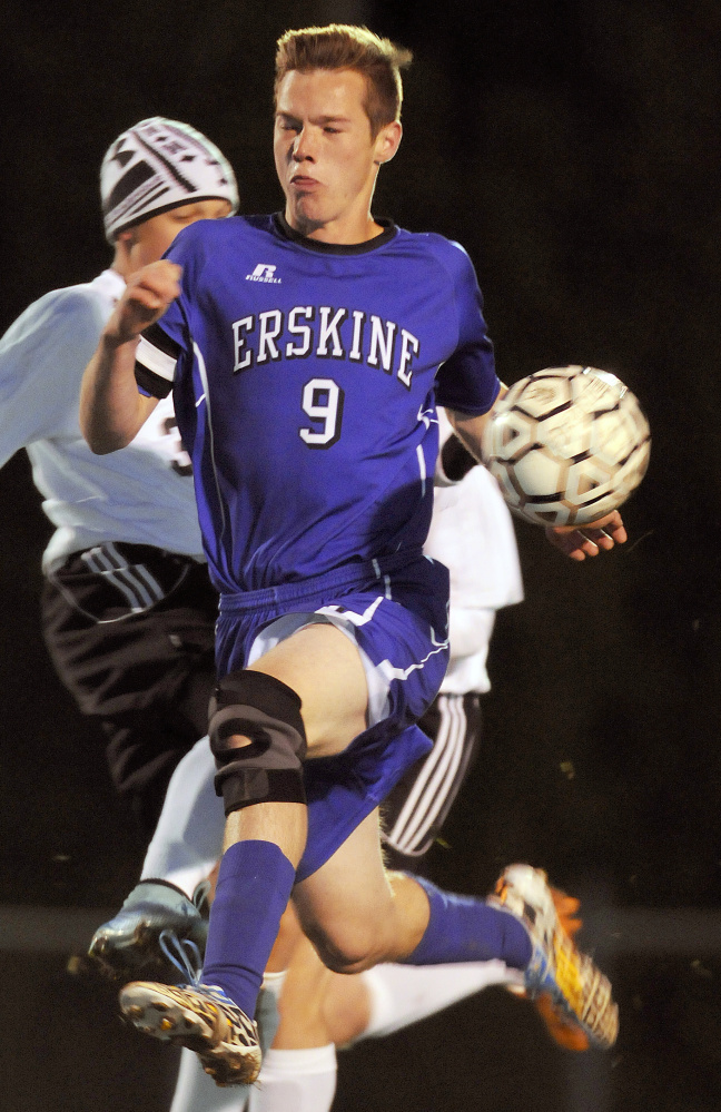 Staff photo by Andy Molloy 
Gardiner's Garrett Lunt, left, kicks the ball away from Erskine's Trevor Hubbard during a Kennebec Valley Athletic Conference Class B game Monday night in Gardiner. The Eagles won, 4-2.