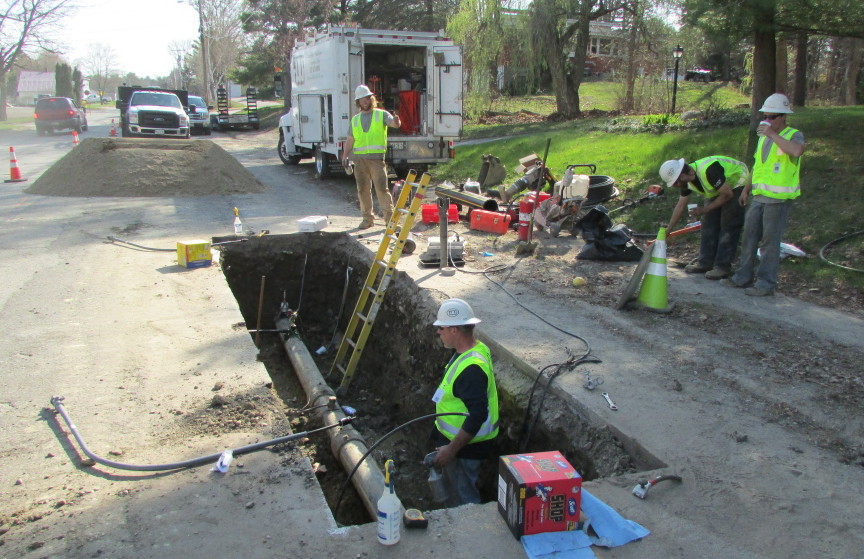 Employees from ETTI, a utilities construction company from Lisbon Falls, replace an electrofusion tee on a Summit Natural Gas line in April on Cool Street in Waterville. Summit has been ordered by state regulators to inspect and replace hundreds additional pipeline connections that may be faulty in several communities, including in Waterville.
