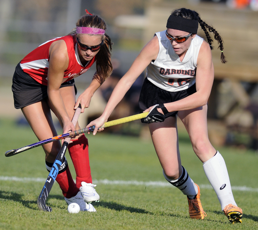 Gardiner Area High School’s Bryce Smith, right, chases the ball with Camden Hills Regional High School’s Emily Daggett during a Class B North quarterfinal game Tuesday in Gardiner.