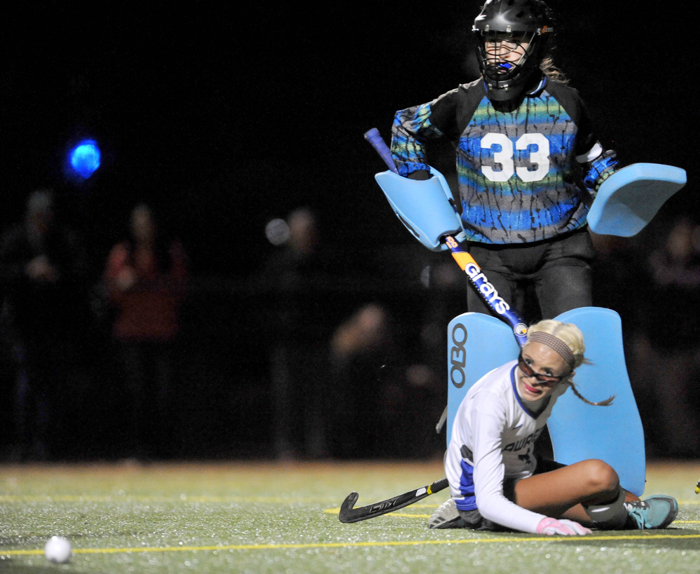 Staff photo by Michael G. Seamans 
 Lawrence junior Hallee Parlin, front, looks to the ball after colliding with Old Town goalie Corinne Saucier during the second half of a Class B North quarterfinal game Tuesday night at Thomas College.