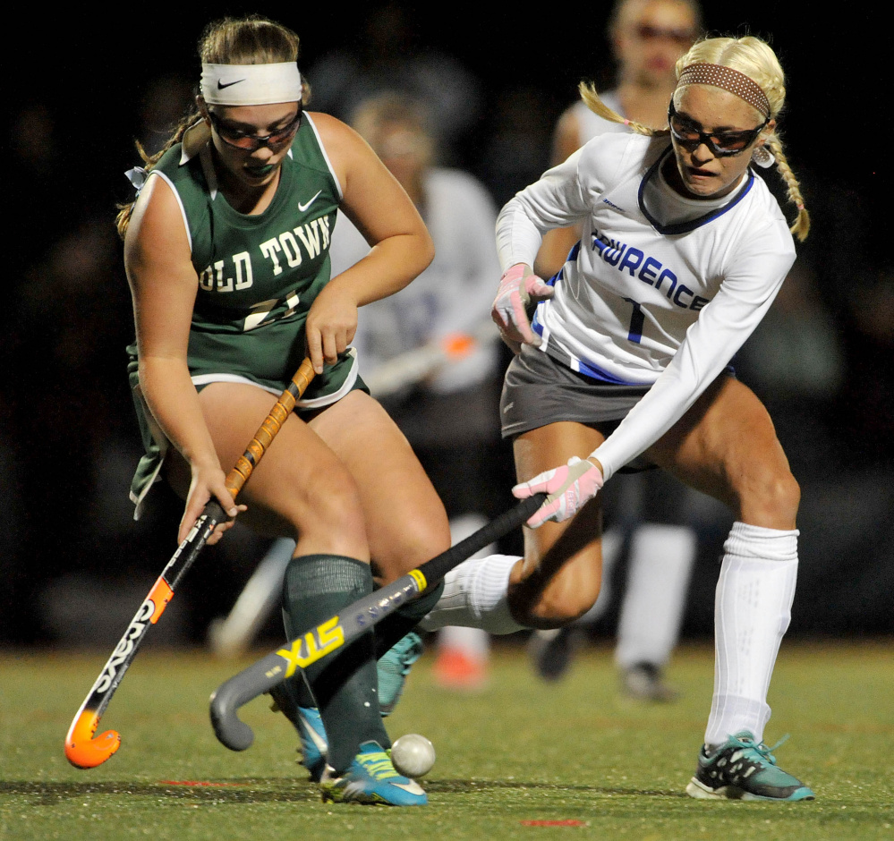 Staff photo by Michael G. Seamans 
 Old Town's Lauren Gasaway, left, battles for the ball with Lawrence junior Hallee Parlin during the second half of a Class B North quarterfinal game Tuesday night at Thomas College.