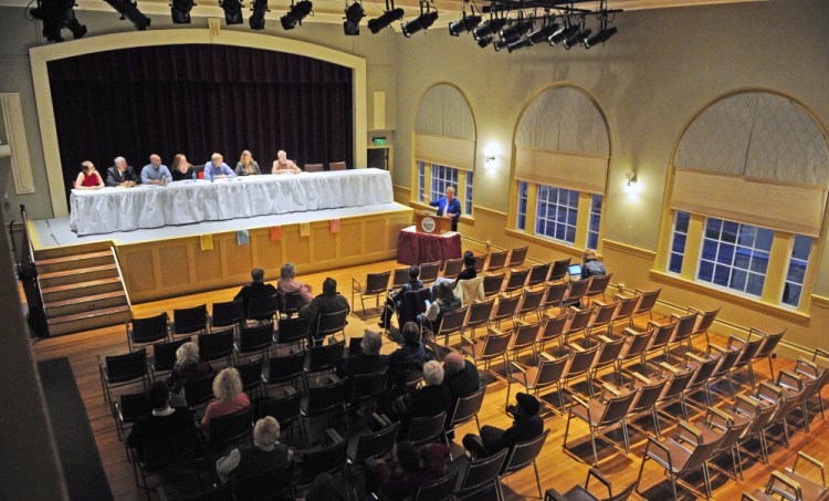 Charlotte Warren, center at podium, introduces candidates on stage at the start of a municipal candidates forum Tuesday at Hallowell City Hall.