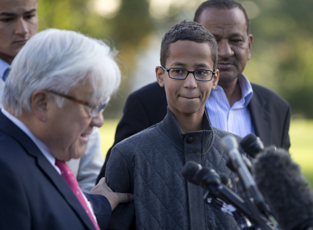 The Associated Press Ahmed Mohamed, second from right, listens as Rep. Mike Honda, D-Calif., left, speaks during a news conference on Capitol Hill in Washington, Tuesday.