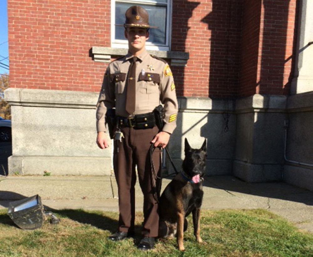 Cpl David Cole of the Somerset County Sheriff’s Department poses Wednesday with the county’s new patrol dog, 15-month old Kojo, a Belgian malinois. Purchase of the dog was approved Wednesday by county commissioners.