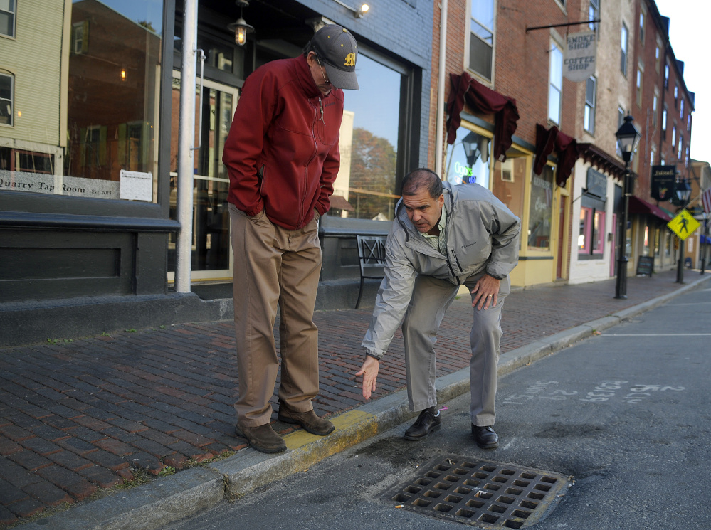 Maine Department of Transportation project engineer Ernie Martin, right, describes to Hallowell City Manager Stefan Pakulski Monday how the agency plans to relocate storm drains on Water Street in the city of Hallowell.