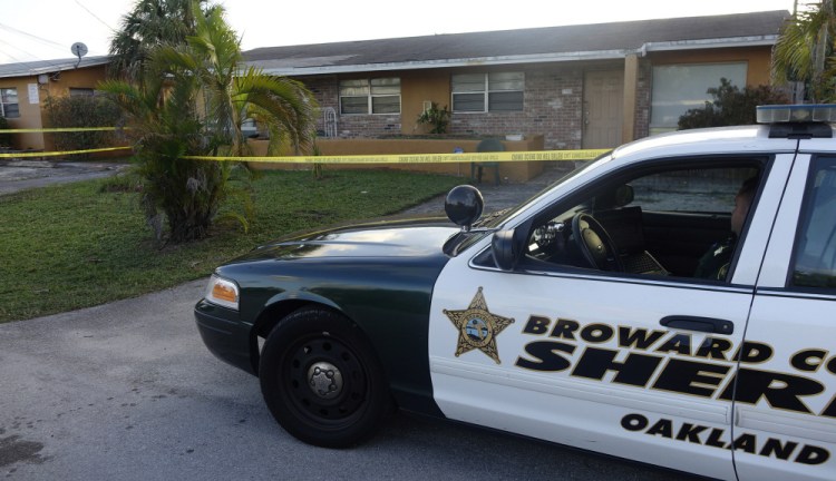 A Broward County, Florida patrol car is seen in Oakland Park on Wednesday outside the home of Charlotte Nicholas, a former Augusta woman who was found dead in her apartment by a neighbor on Tuesday.