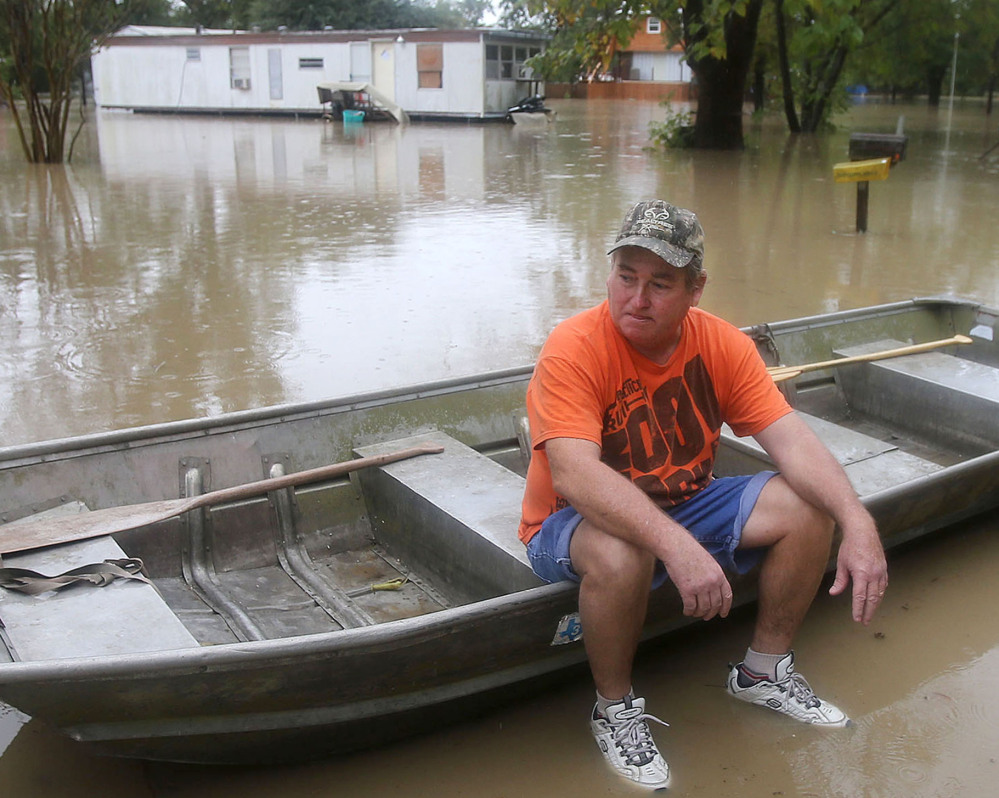 J.B. Neckar, waits in his boat as waters rise near Downsville, Texas, Saturday, Oct. 24, 2015. Heavy rains have forced parts of the Brazos River out of its banks and endangering homes located in the small community just outside of Waco, Texas, according to the Waco Tribune Herald. (Jerry Larson/Waco Tribune Herald, via AP) MANDATORY CREDIT