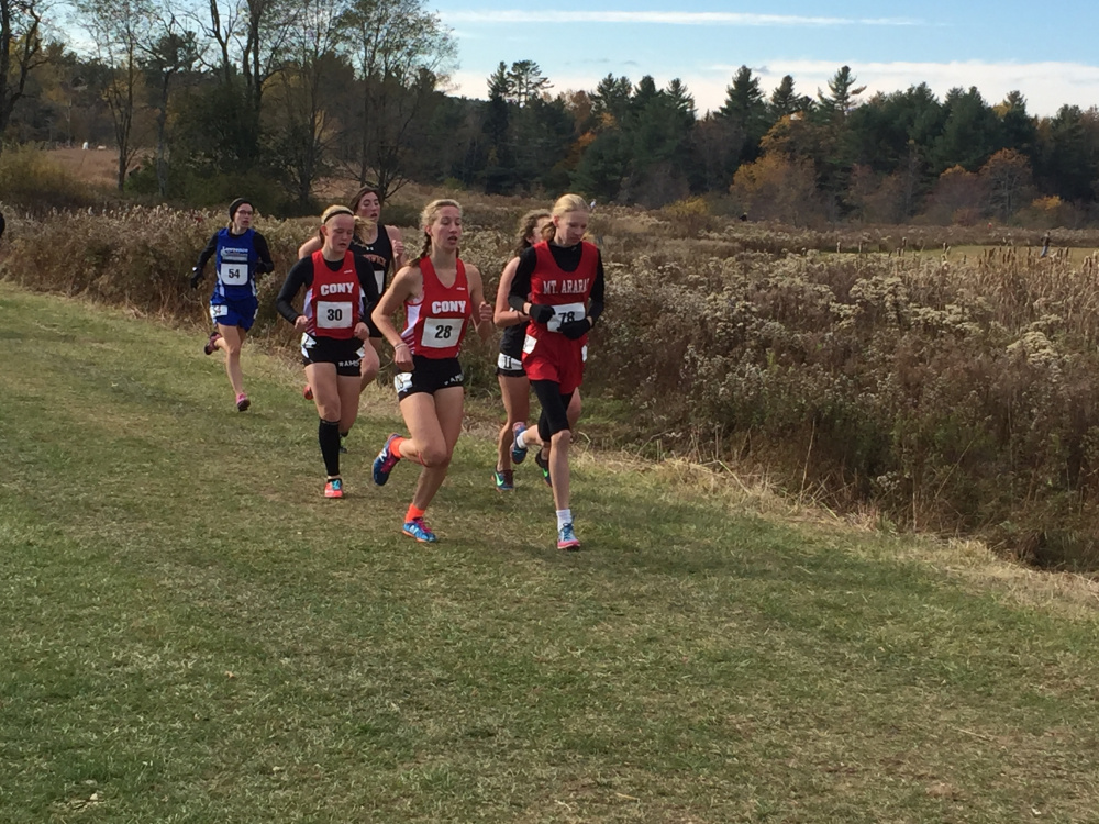 Staff photo by Randy Whitehouse 
 Cony's Anne Guadalupi, left, runs with teammate Talia Jorgensen, behind, during the Class A North cross country championships in Belfast on Saturday. At right is Mt. Ararat runner Katherine Leckbee.