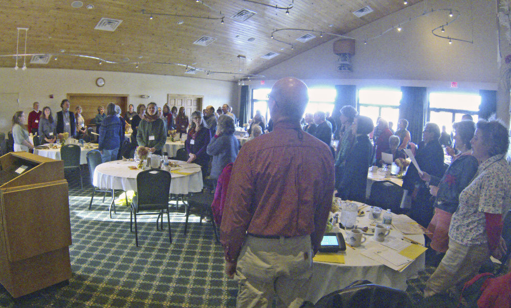 Participants stand as they sing together at the start of the Singing For Those at the End of Life conference Saturday at Maple Hill Farm Inn and Conference Center in Hallowell.