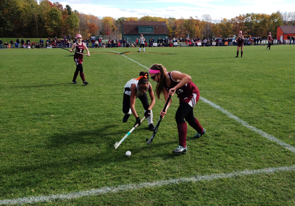 Staff photo by Evan Crawley 
 Winslow's Samantha Washburn, left, tries to gain possession of the ball as Foxcroft's Mariah Poulin defends during a Class B North semifinal game Saturday in Winslow.