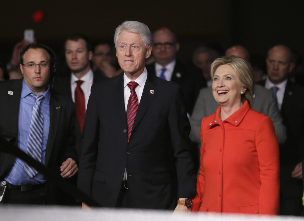 Former President Bill Clinton and his wife, Democratic presidential candidate Hillary Rodham Clinton, walk back to the stage after the Iowa Democratic Party’s Jefferson-Jackson fundraising dinner, Saturday in Des Moines, Iowa.