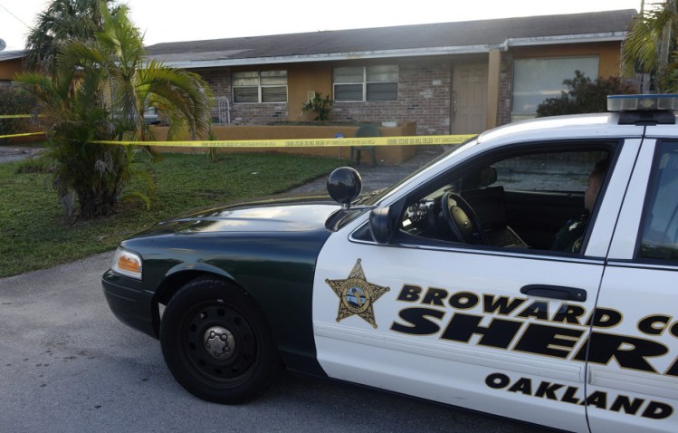 A Broward County, Florida patrol car is seen in Oakland Park on Wednesday outside the home of Charlotte Nicholas, a former Augusta woman who was found dead in her apartment by a neighbor.