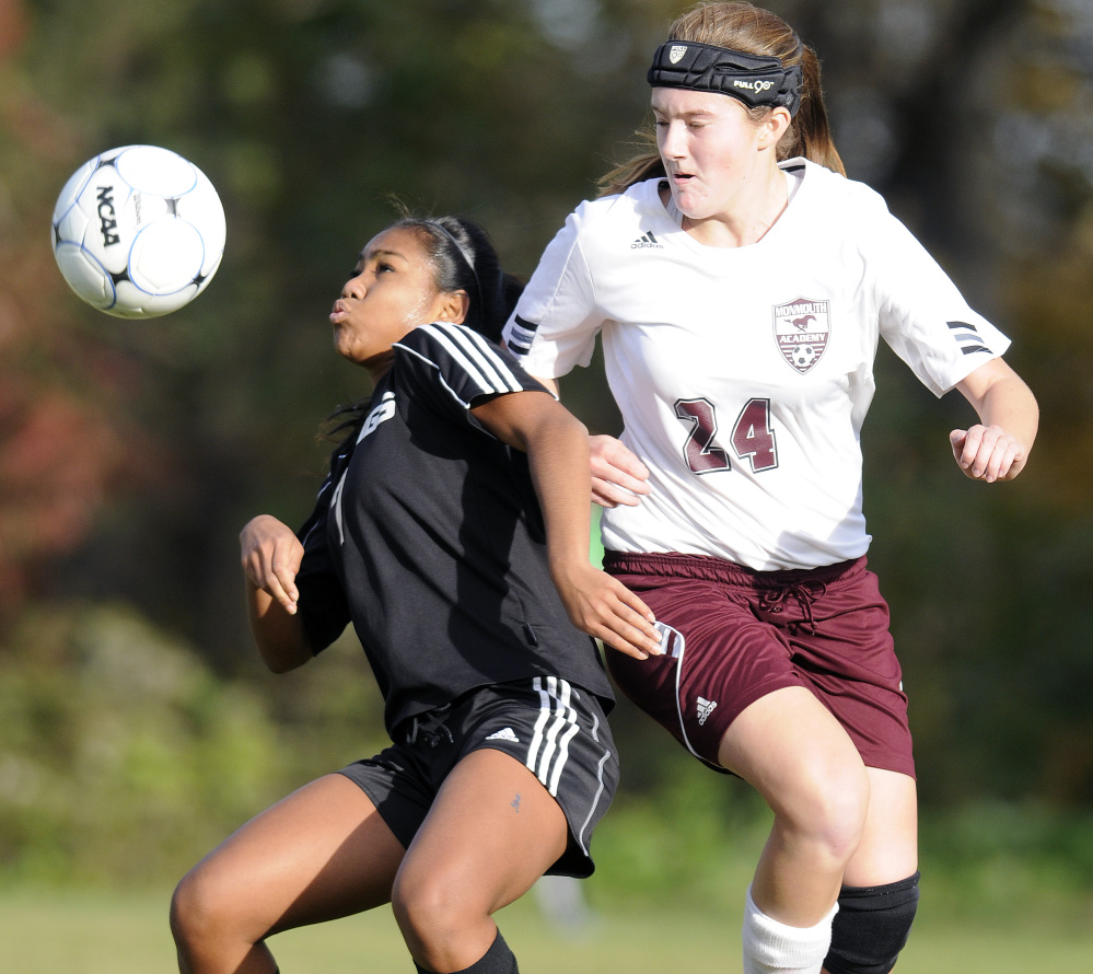 Hall-Dale High School's Thea Sweet, left, attempts to head the ball away from Monmouth Academy's Abby Allen during a Class C South quarterfinal game Tuesday.
