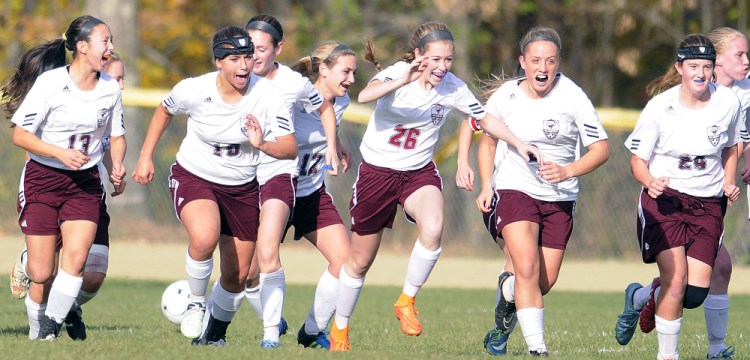 Members of the Monmouth girls soccer team celebrate a goal against Hall-Dale during a Class C South quarterfinal Tuesday.