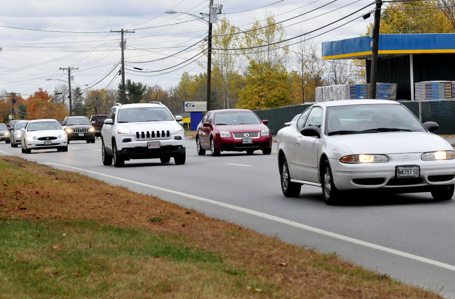 Traffic moves on four-lane Kennedy Memorial Drive in Oakland on Wednesday.  The Maine Department of Transportation is proposing a center turn lane for the road to accommodate increasing development on the road, including a planned Dunkin’ Donuts.