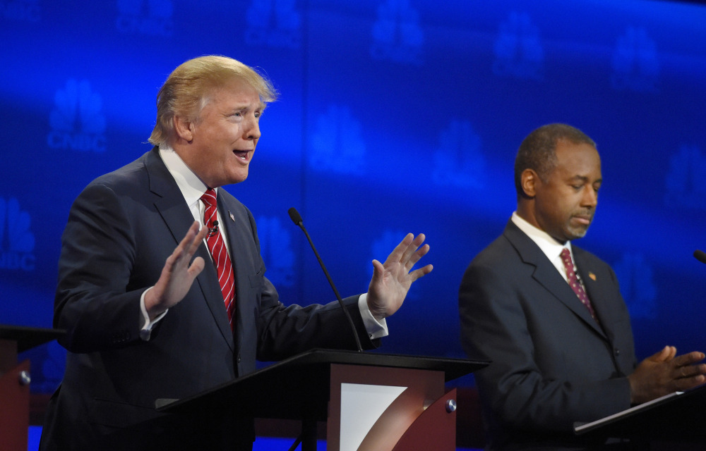 Donald Trump makes a point as Ben Carson listens during the early going in Wednesday night’s debate. The two are the front-runners in the polls.