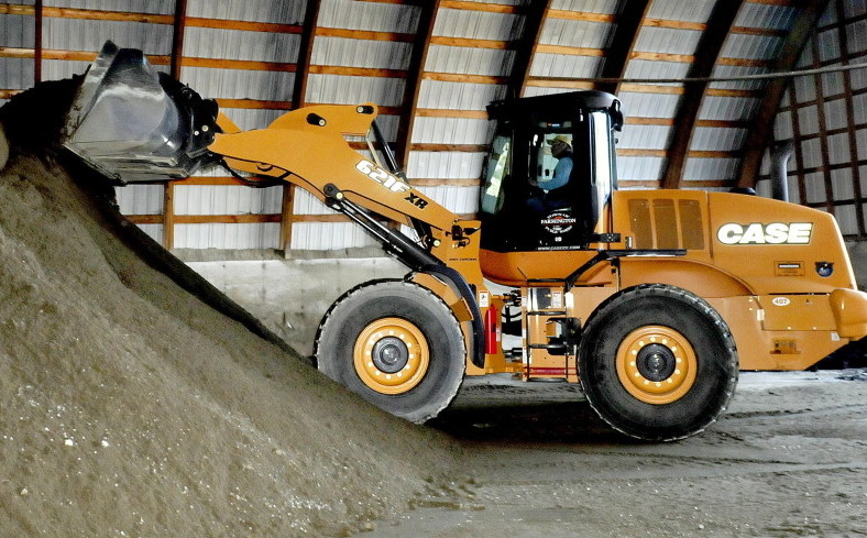 Farmington Public Works Director Denis Castonguay loads sand for plow trucks in January before a big storm. Castonguay was to retire before the winter season began, but the town is keeping him on until spring, because they can’t find a replacement.