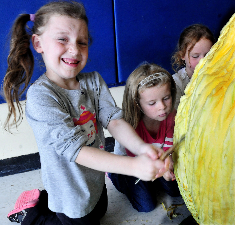 North School Elementary student Savana Ward grimaces as she and Lucy Hitchins carve a pumpkin at the Skowhegan school on Thursday.