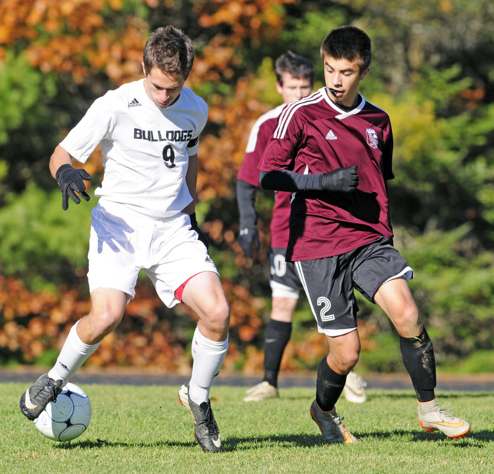 Hall-Dale’s Tyler Dubois, left, and Monmouth Academy’s Avery Pomerleau battle for the ball during a Class C South semifinal game Wednesday afternoon in Farmingdale. Pomerleau would score in double overtime to give Monmouth a dramatic 2-1 victory.