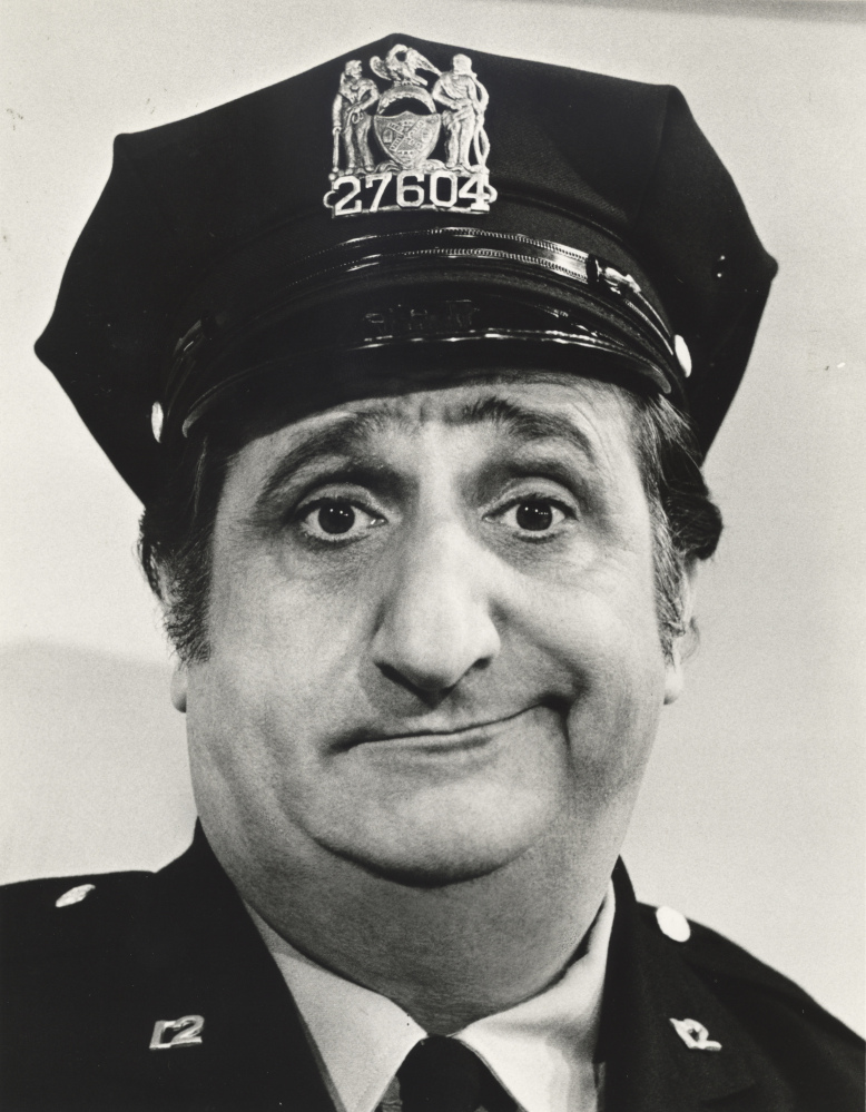 In a photo, provided in 1974 by ABC, actor Al Molinaro poses dressed as Murray the cop. Molinaro, the loveable character actor with the hangdog face who was known to millions of TV viewers for playing Murray on “The Odd Couple” and malt shop owner Al Delvecchio on “Happy Days,” died Friday.