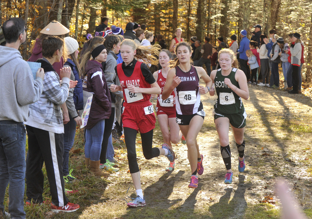 Class A girls runners, from left, Kathrine Leckbee (Mt. Ararat), Serena McKenzie (South Portland), Anna Slager (Gorham), and Bonnie Eagle’s Kialeigh Marston lead the pack midway into Saturday’s race at Twin Brook Recreation Area in Cumberland.