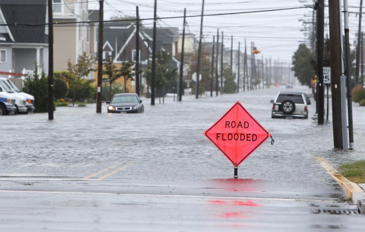 A car is stuck in floodwaters along Central Avenue in Sea Isle City, N.J., on Friday. New Jersey got pounded by heavy rain and strong winds that were expected to bring coastal flooding this weekend, even though the state is no longer in the anticipated path of Hurricane Joaquin.
Lori M. Nichols/Gloucester County Times via AP