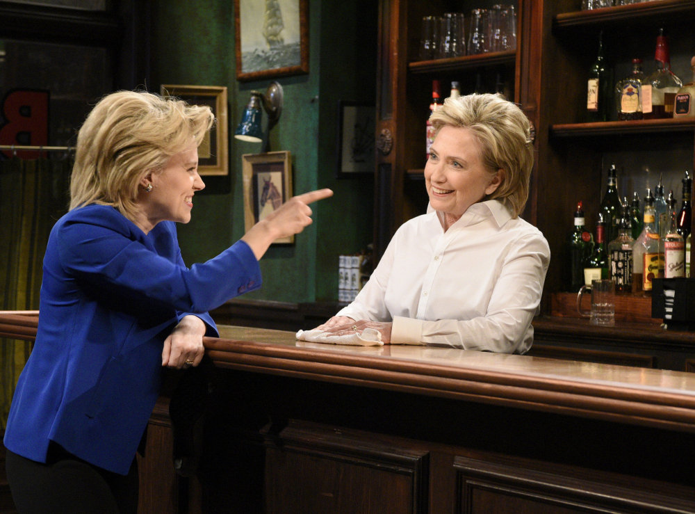 Kate McKinnon, left, portrays Hillary Clinton, and Hillary Clinton, right, portrays Val, a bartender, during a sketch on “Saturday Night Live” in New York on Saturday. 