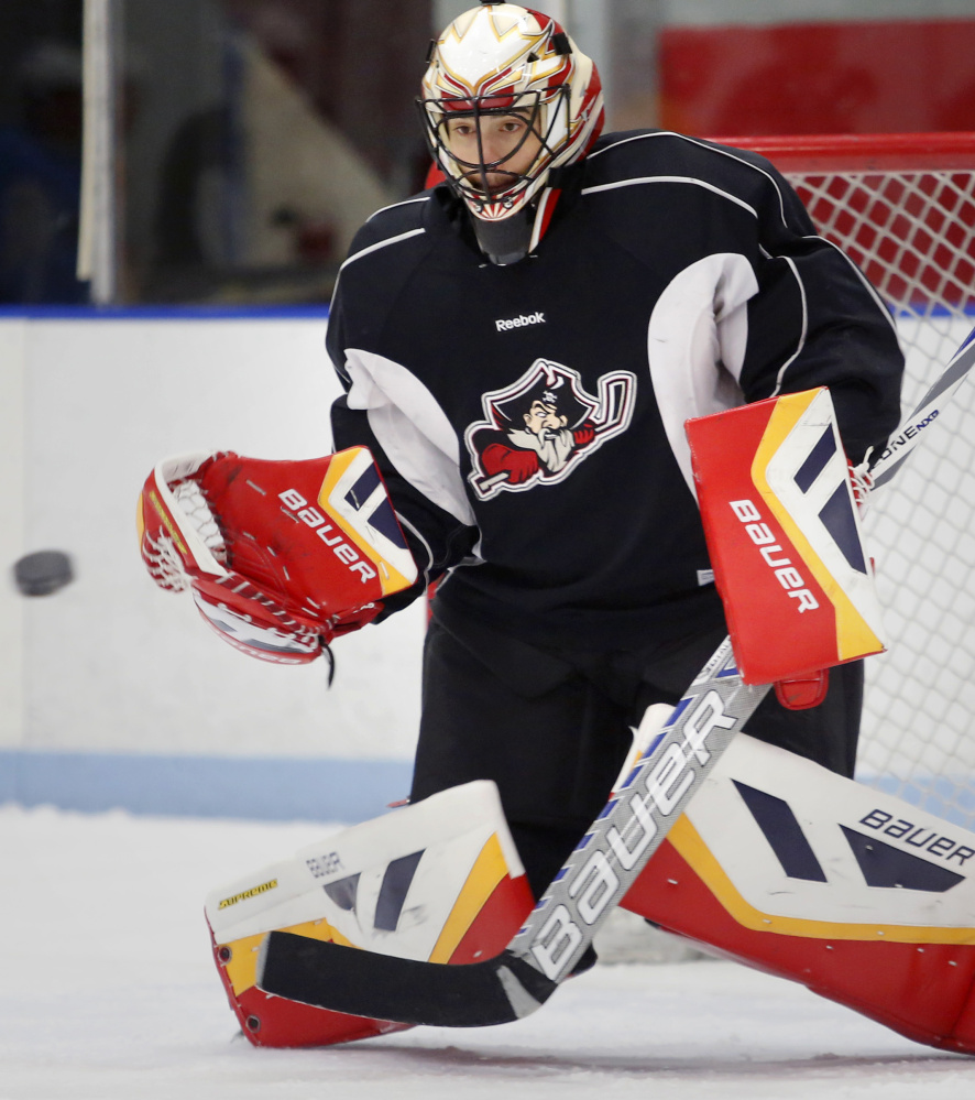 Mike McKenna makes a save during Pirates practice in Saco. The goalie is the lone holdover from last year’s team, and will be playing in a Portland uniform under a third NHL affiliate since 2007-08.