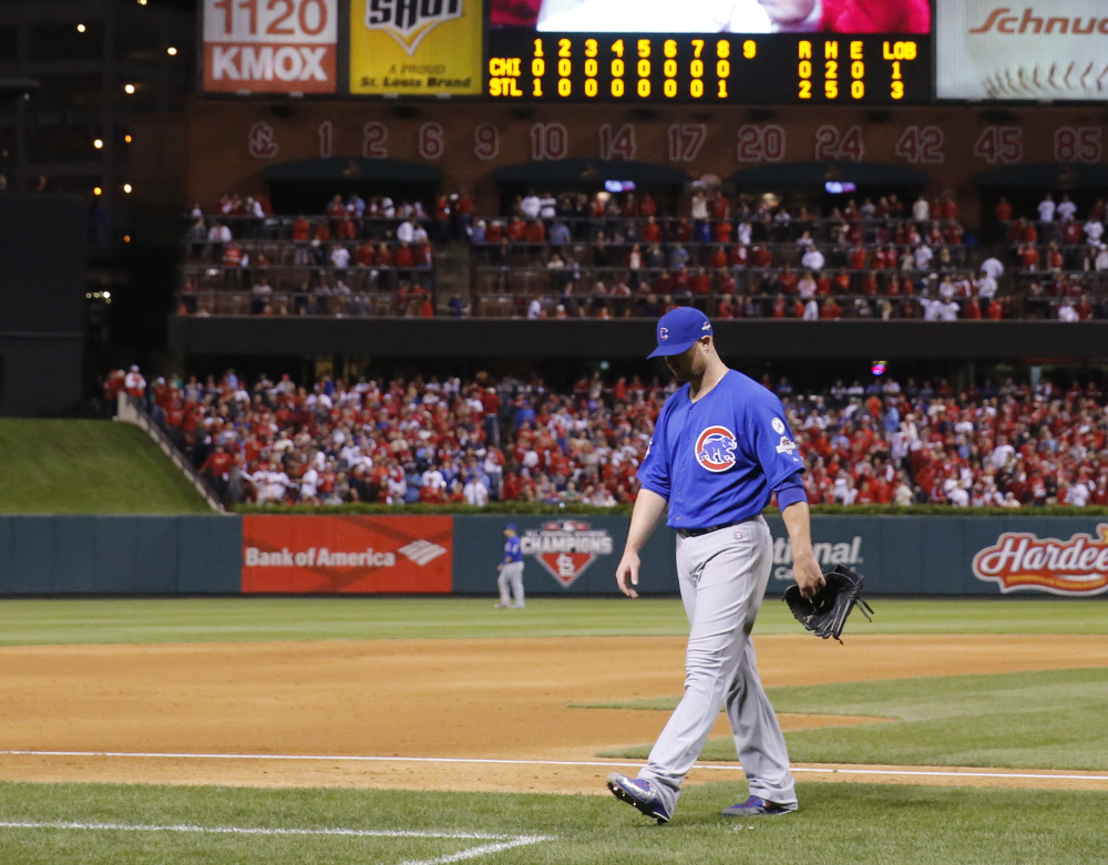 Cubs starter Jon Lester walks to the dugout after being taken out in the eighth inning. The one-time Red Sox ace held the Cardinals to five hits, but his former teammate John Lackey outpitched him.