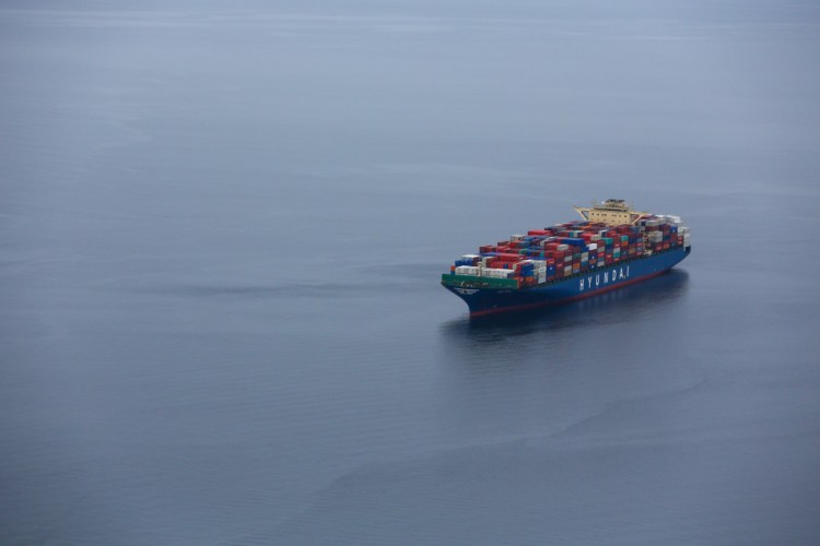 A container ship sits at anchor in Elliott Bay outside the Port of Seattle in February.