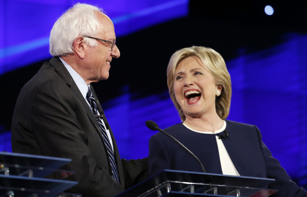Sen. Bernie Sanders of Vermont and former Secretary of State Hillary Clinton share a laugh at the CNN Democratic presidential debate Tuesday evening in Las Vegas.