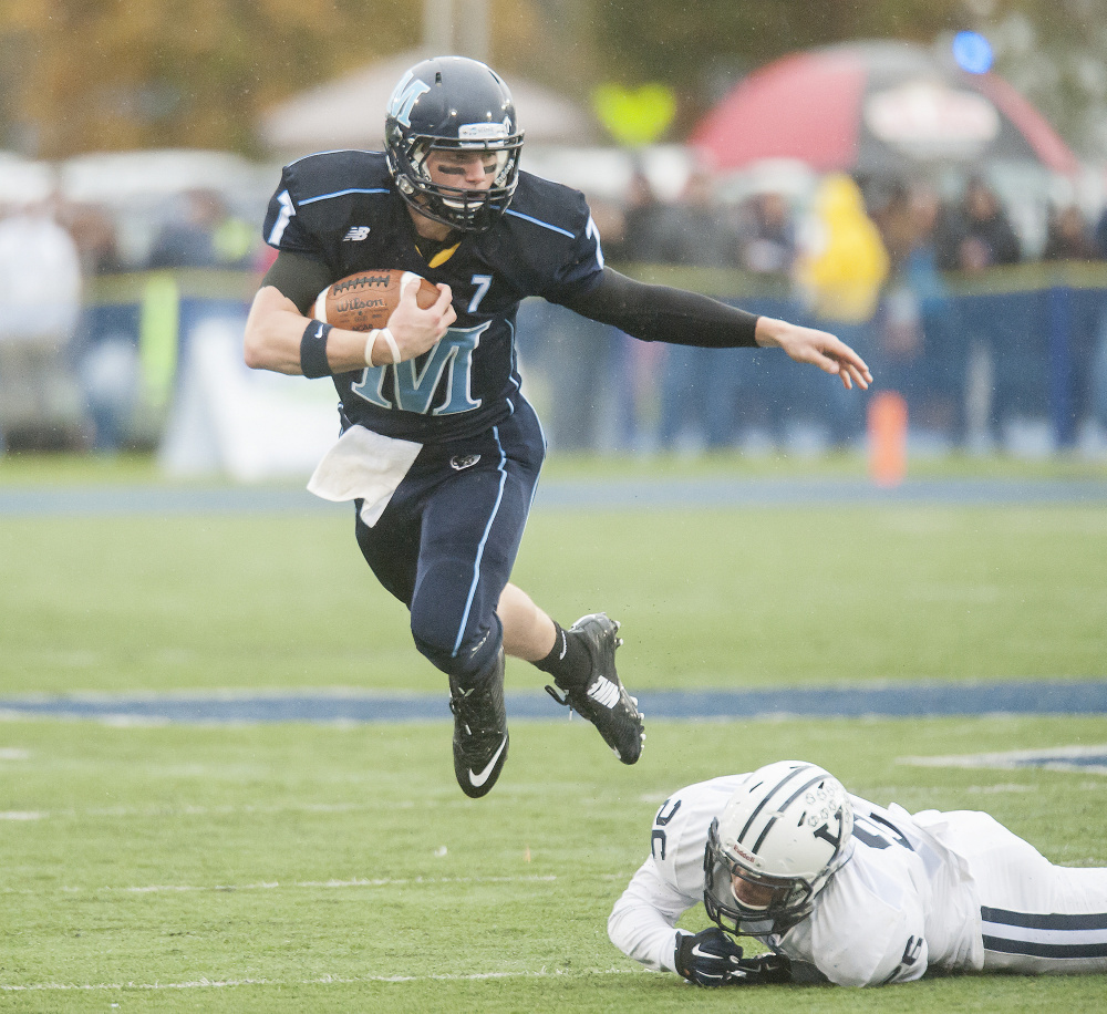 Maine quarterback Dan Collins escapes from Hayden Carlson of Yale in the first half. Collins was 19 of 49 for 199 yards.