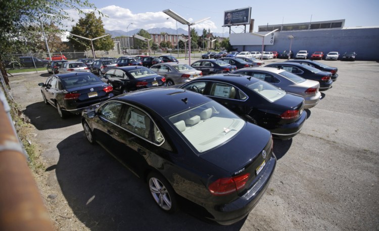 Volkswagen diesel cars are shown are parked in a storage lot near a VW dealership in Salt Lake City. Some legal experts say the automaker could be forced to buy back the cars.