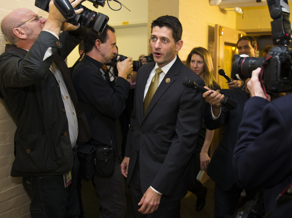 Rep. Paul Ryan, R-Wis. is surrounded by media as he arrives for a House Republican conference meeting Wednesday on Capitol Hill. Ryan is seeking unity in a place it’s rarely found, telling House Republicans he will serve as their speaker only if they embrace him by week’s end as their consensus candidate.