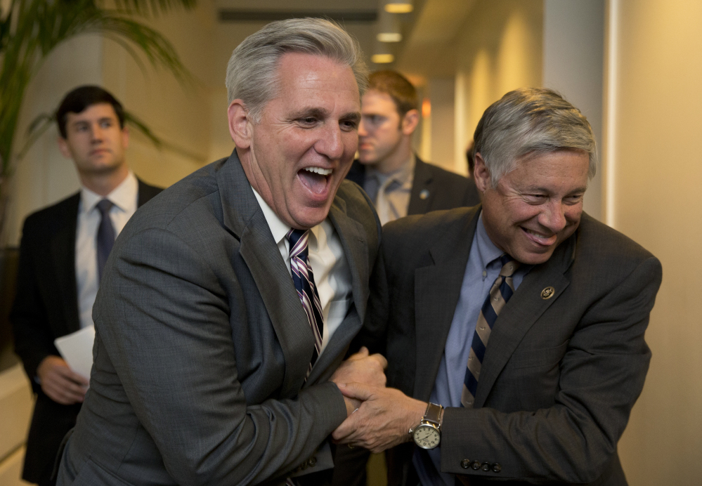 House Majority Leader Kevin McCarthy of California, left, and Rep. Fred Upton, R-Mich., laugh as they walk from a meeting on Capitol Hill Monday.