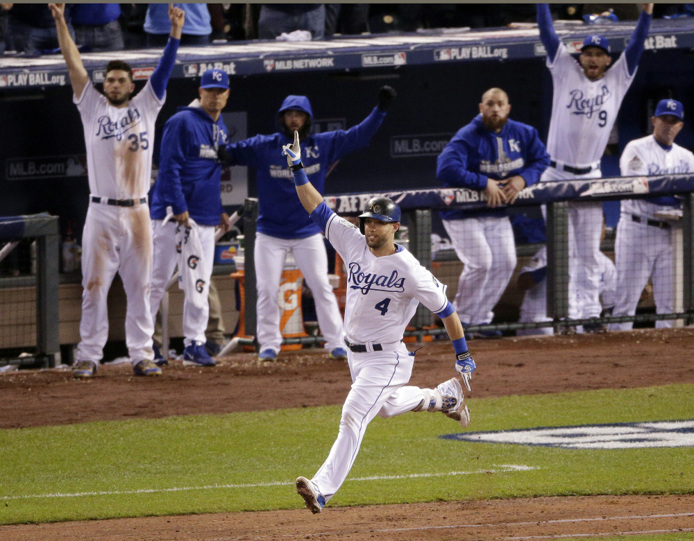 Kansas City’s Alex Gordon celebrates the solo home run that tied the game in the ninth inning. The teams played five more innings before the Royals broke the 4-4 tie.