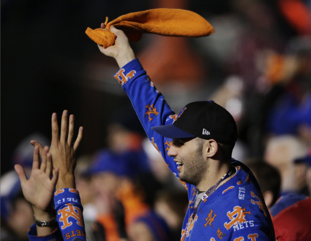 A New York Mets fan cheers during the seventh inning of Game 3 of the World Series against the Kansas City Royals on Friday in New York. (AP Photo/Charlie Riedel)