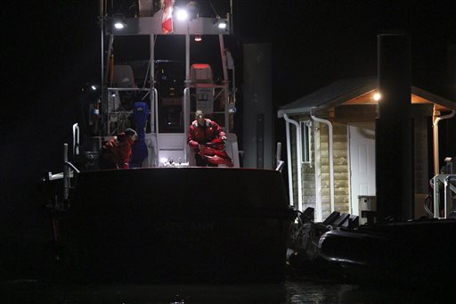 Canadian Coast Guard crew arrive at a dock in Tofino, west coast of Vancouver, Canada, early Monday following a search and rescue operation for people who were on board a whale watching boat when it sank off Vancouver Island on Sunday. The Associated Press
