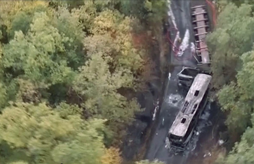 This image taken from video shows the scene after a truck and a bus transporting retirees on a day trip collided and caught fire Friday in southwest France, killing 43-people. Télé FRANCE TV via AP