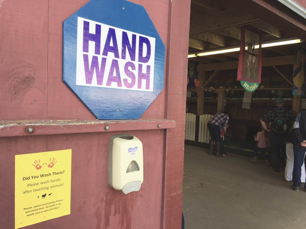 A hand-washing station is mounted outside a barn at the petting zoo at the Fryeburg Fair on Wednesday. It's still unclear whether the petting zoo at the Oxford County Fair was the root cause of the E. coli infections that killed one toddler and sent another to the hospital.