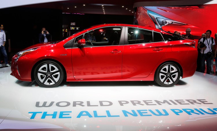 Visitors gather around the new Toyota Prius premiered on the first day of the Frankfurt Auto Show in Frankfurt, Germany. Toyota says the U.S. model will get get 55 mpg in combined city and highway driving, about 10 percent better the current model. The Associated Press