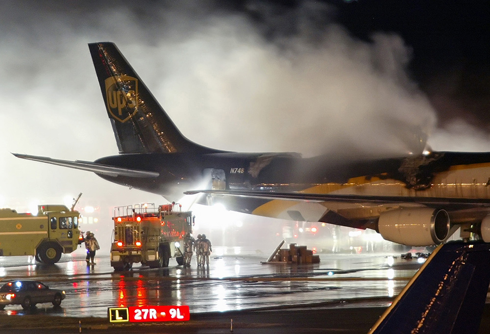 Firefighters battle a blaze onboard a UPS cargo plane at Philadelphia International Airport in this 2008 file photo. The risk of fire is prompting federal officials to back a proposed ban on shiipments of rechargeable lithium-ion batteries as cargo on passenger airlines. The Associated Press