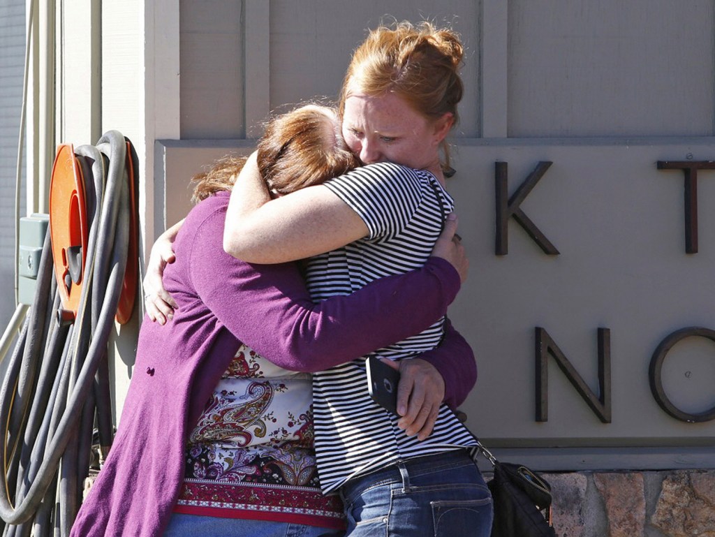 Umpqua Community College alumnus Donice Smith, left, is embraced last week after she said one of her former teachers was shot dead, near the site of the mass shooting in Roseburg, Oregon. 